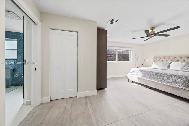 a bedroom with a bed and a tv