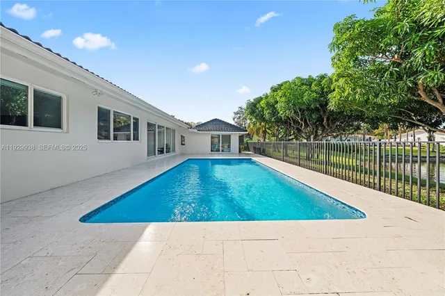 a view of house with yard and swimming pool