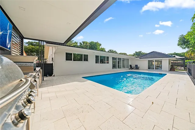 a view of a house with a wooden fence