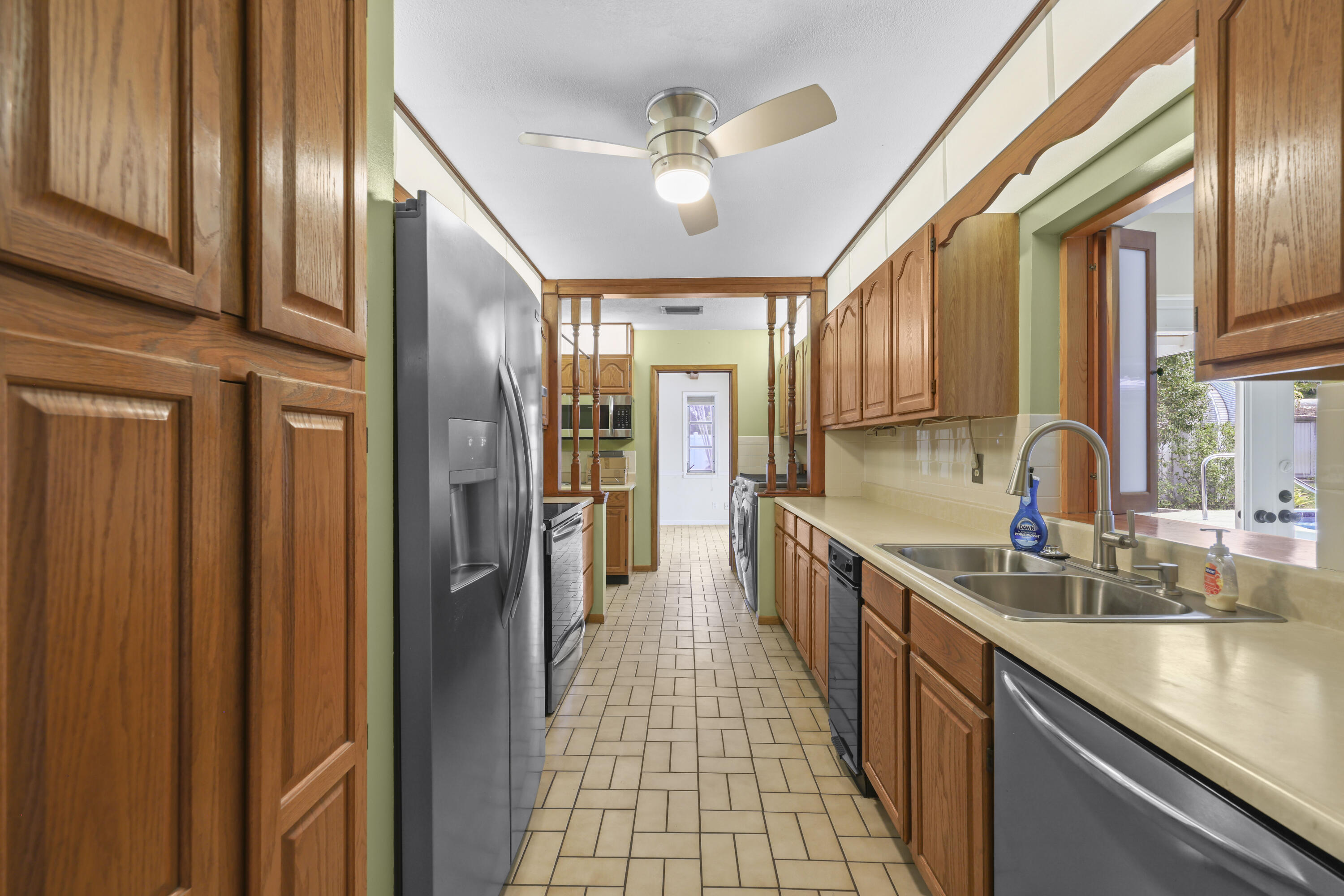 1720 Southwest 10th Street Boca Raton, FL 33486 - Photo 12 of 57 a kitchen with stainless steel appliances granite countertop a sink and cabinets