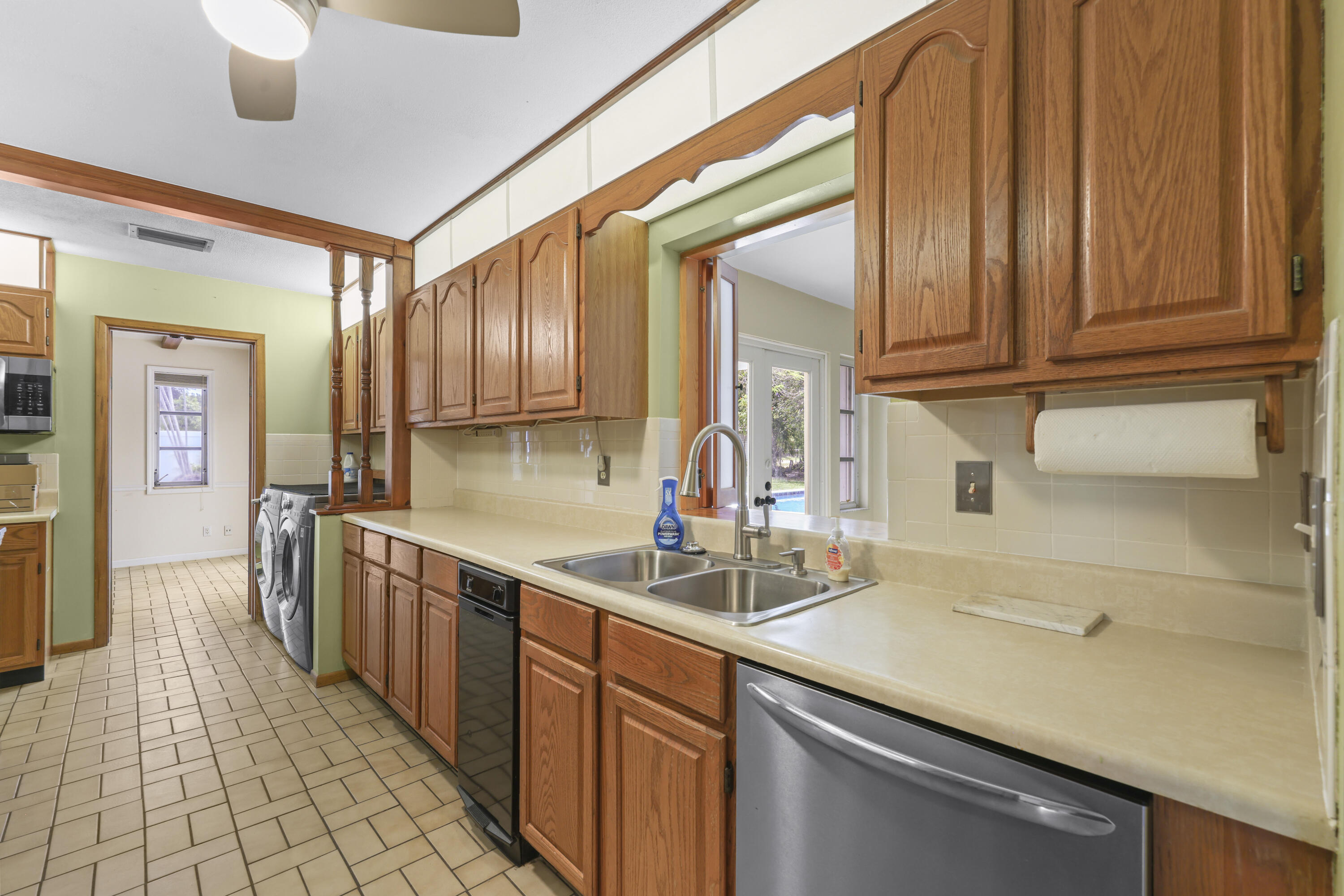 1720 Southwest 10th Street Boca Raton, FL 33486 - Photo 13 of 57 a kitchen with stainless steel appliances granite countertop a sink stove and cabinets