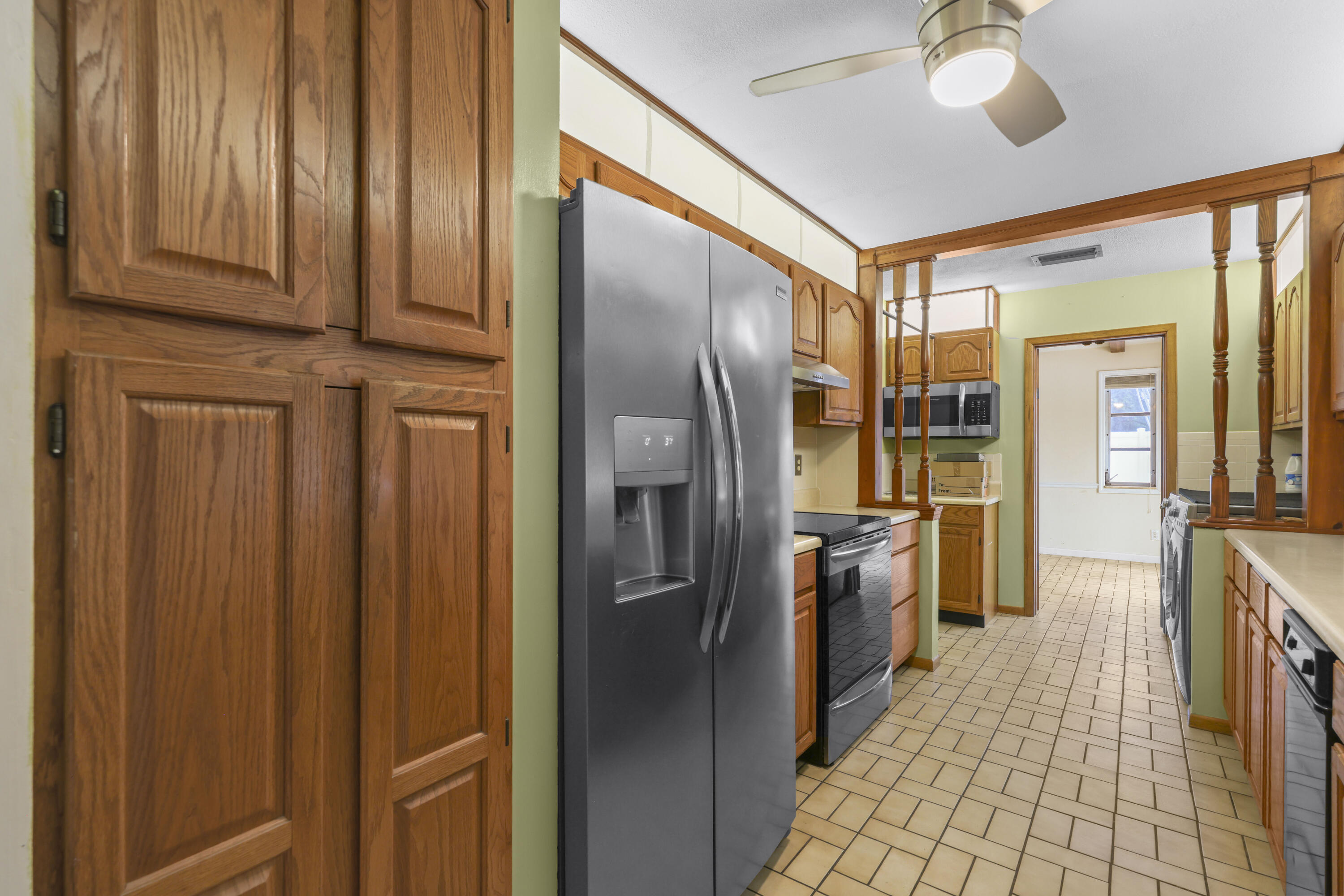 1720 Southwest 10th Street Boca Raton, FL 33486 - Photo 14 of 57 a kitchen with stainless steel appliances granite countertop a refrigerator and a sink