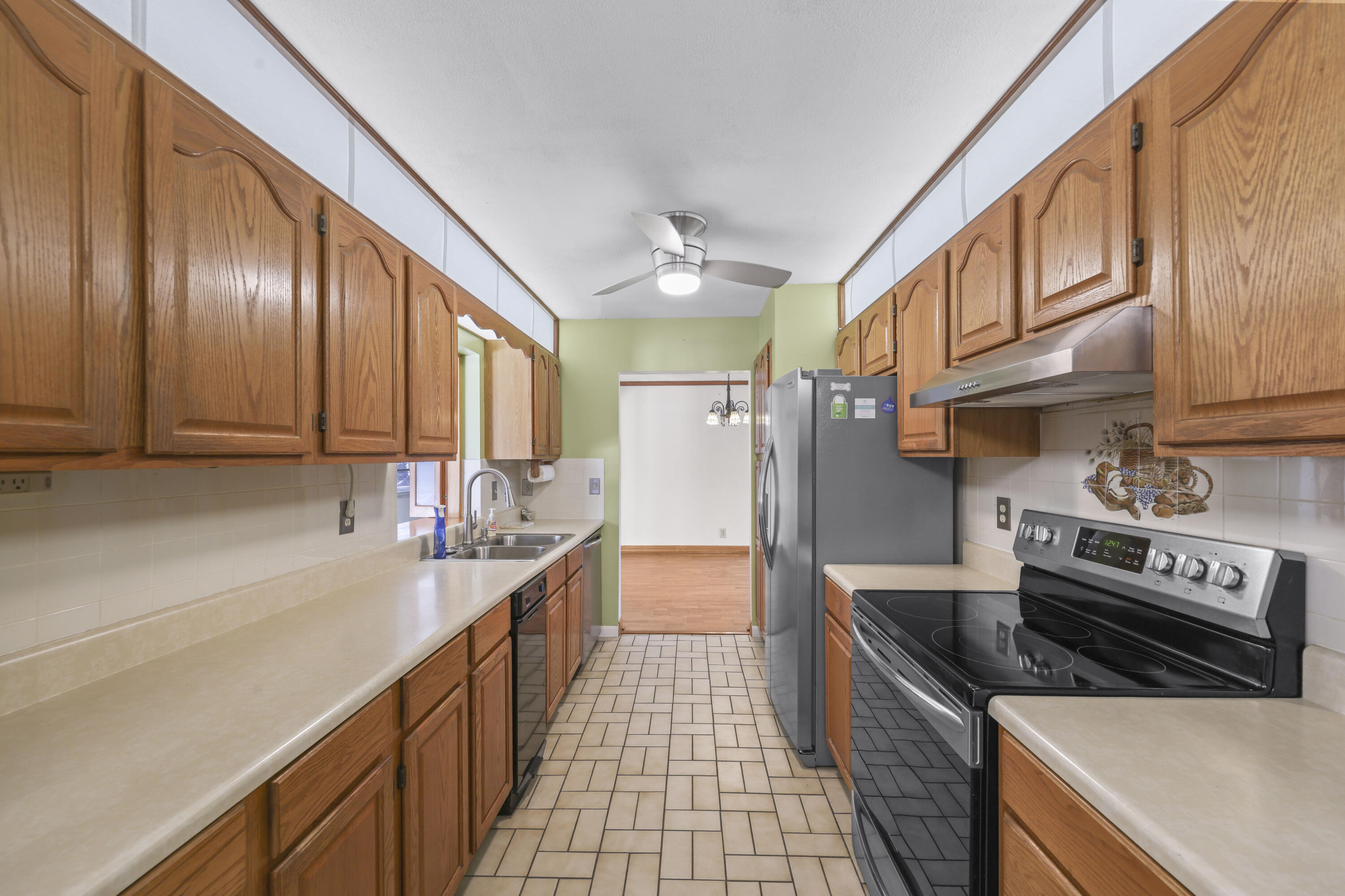 1720 Southwest 10th Street Boca Raton, FL 33486 - Photo 17 of 57 a kitchen with stainless steel appliances granite countertop a sink a stove and a refrigerator