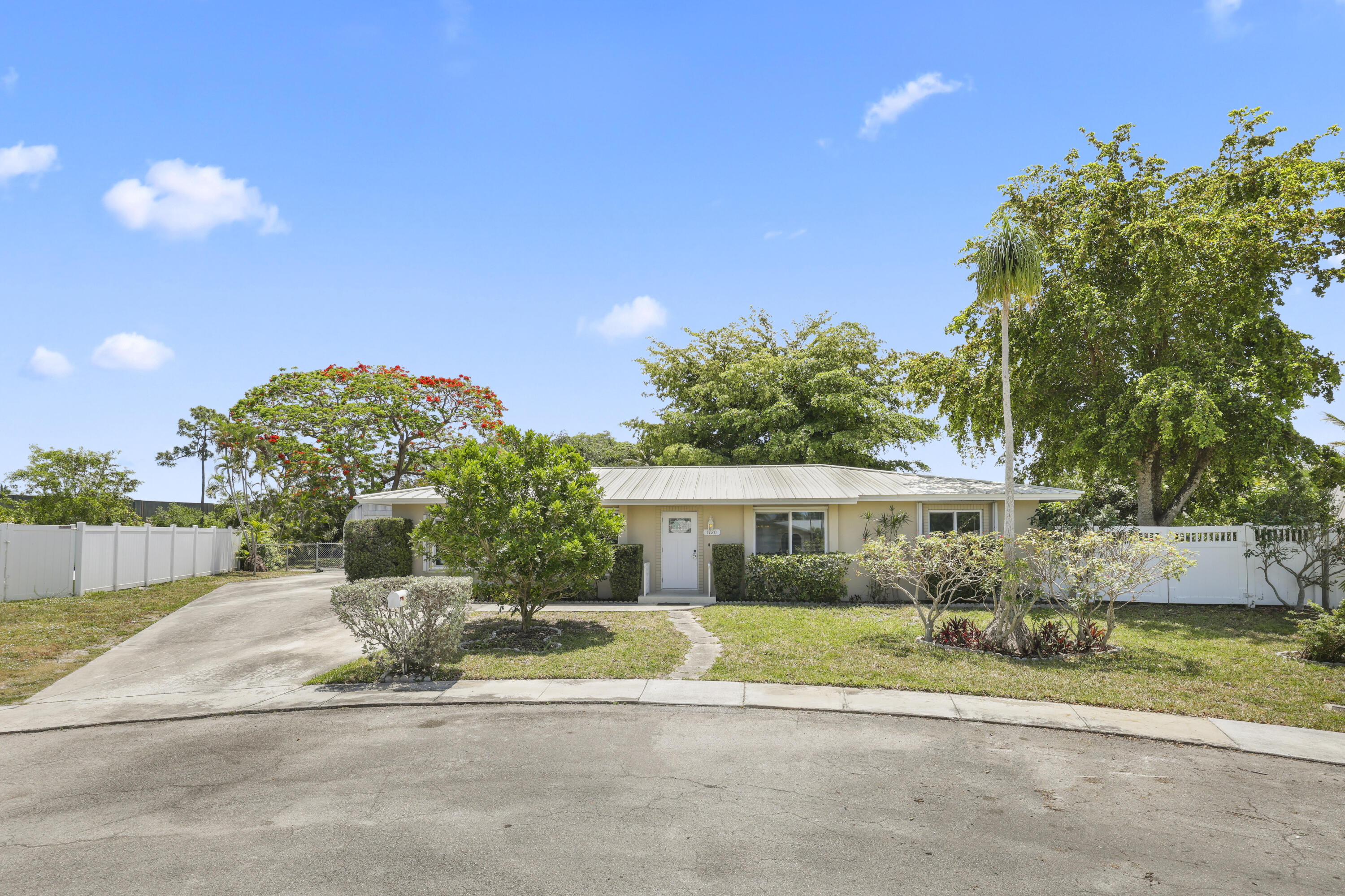 1720 Southwest 10th Street Boca Raton, FL 33486 - Photo 2 of 57 a front view of a house with a yard