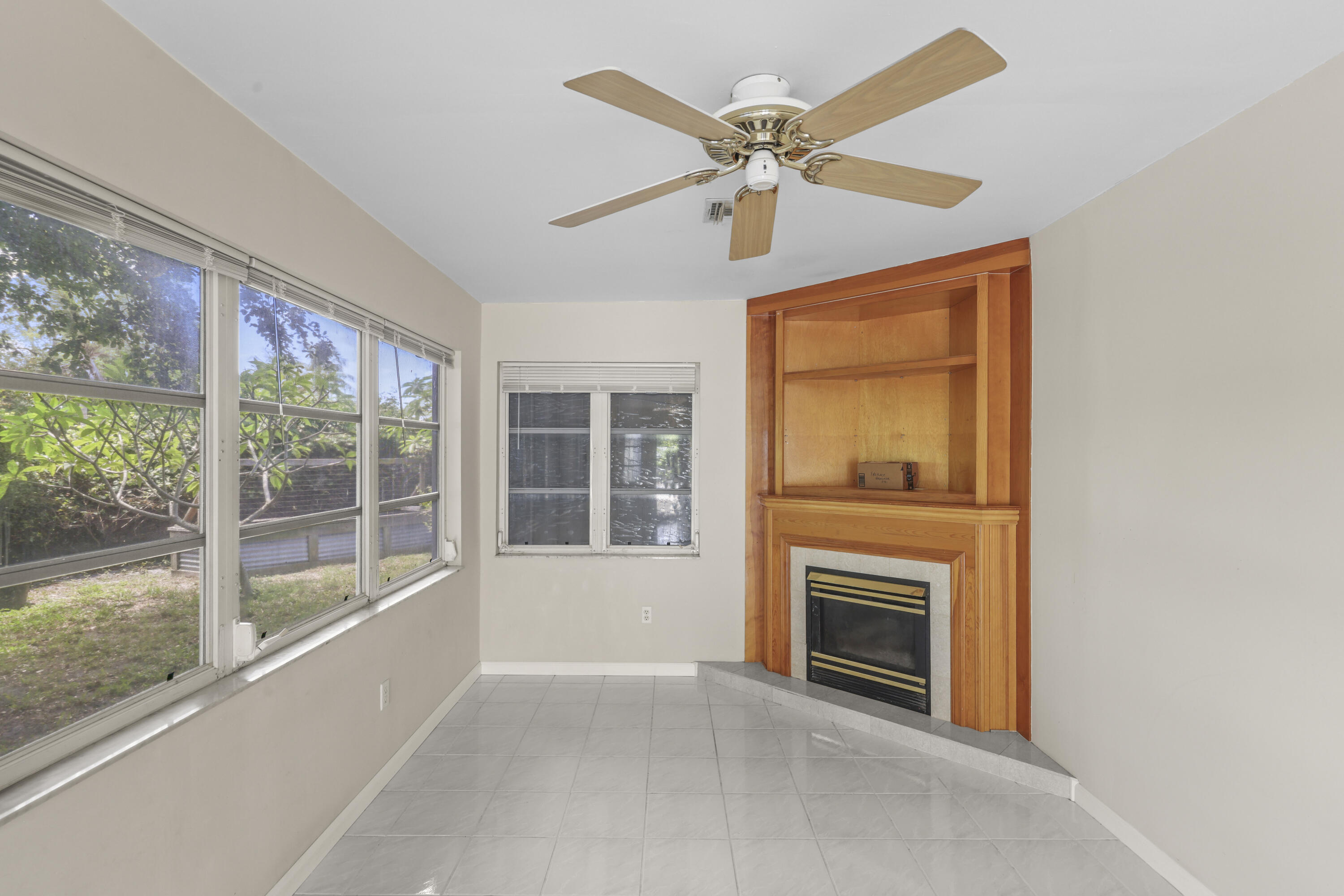 1720 Southwest 10th Street Boca Raton, FL 33486 - Photo 25 of 57 wooden floor fireplace and windows in an empty room