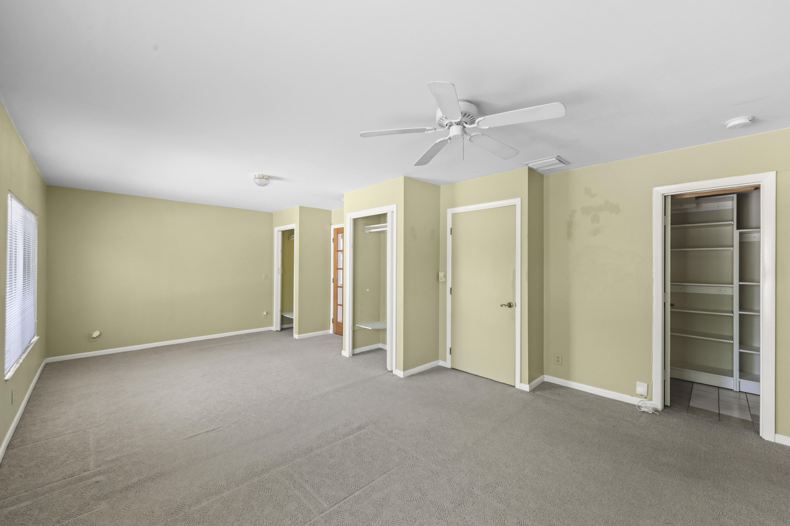 1720 Southwest 10th Street Boca Raton, FL 33486 - Photo 29 of 57 an empty room with closet and a ceiling fan