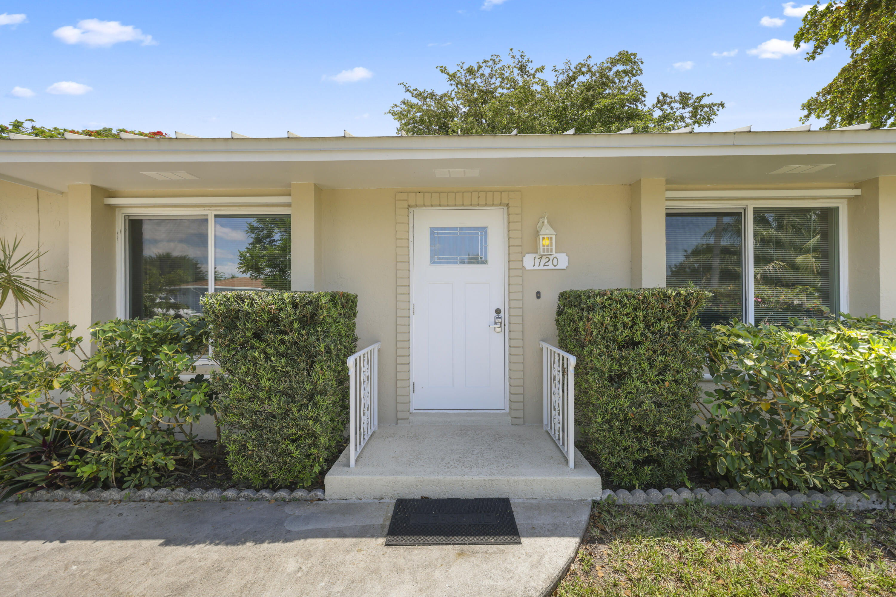 1720 Southwest 10th Street Boca Raton, FL 33486 - Photo 3 of 57 front view of a house with a yard