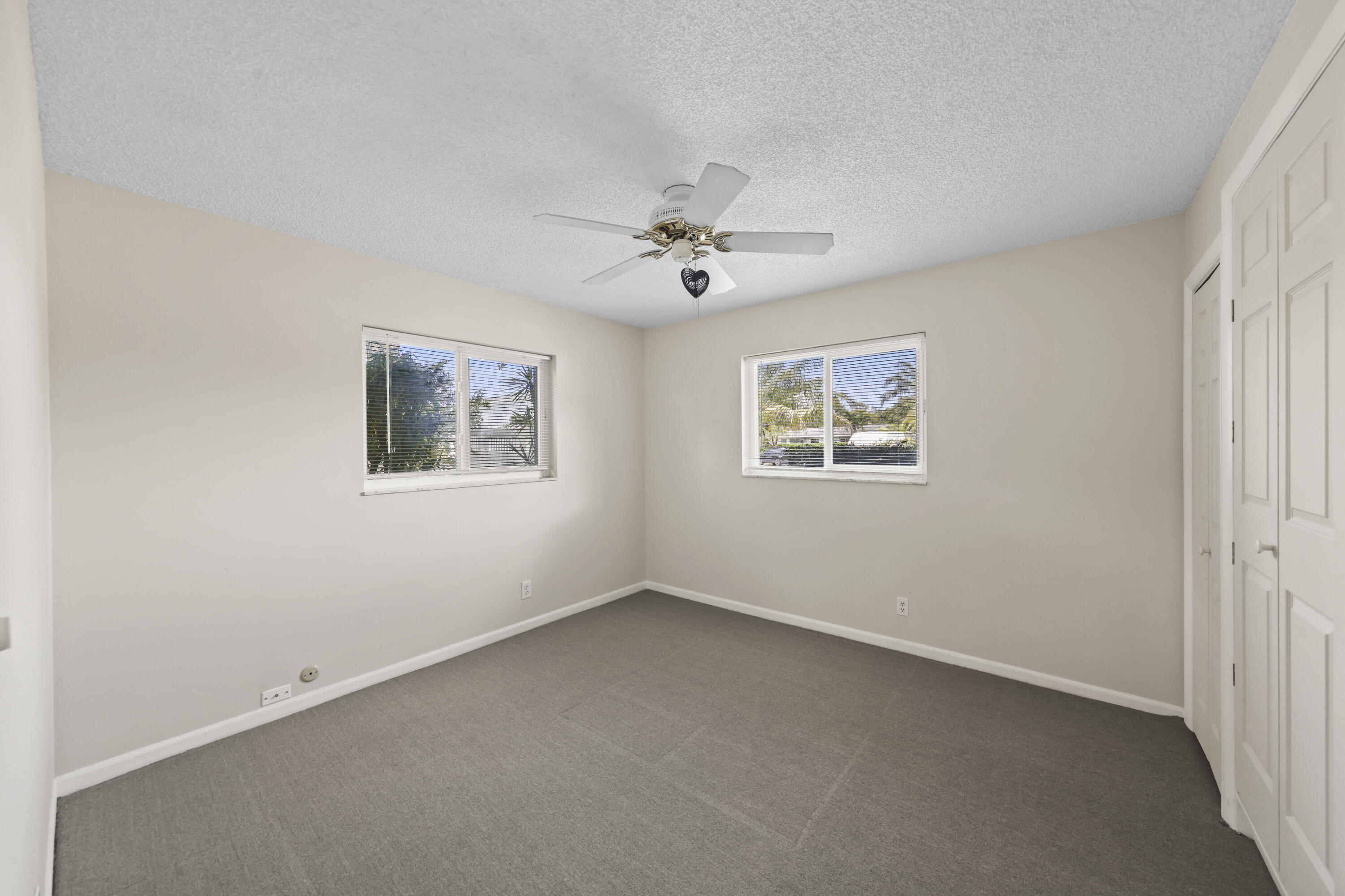 1720 Southwest 10th Street Boca Raton, FL 33486 - Photo 33 of 57 an empty room with a window and a ceiling fan
