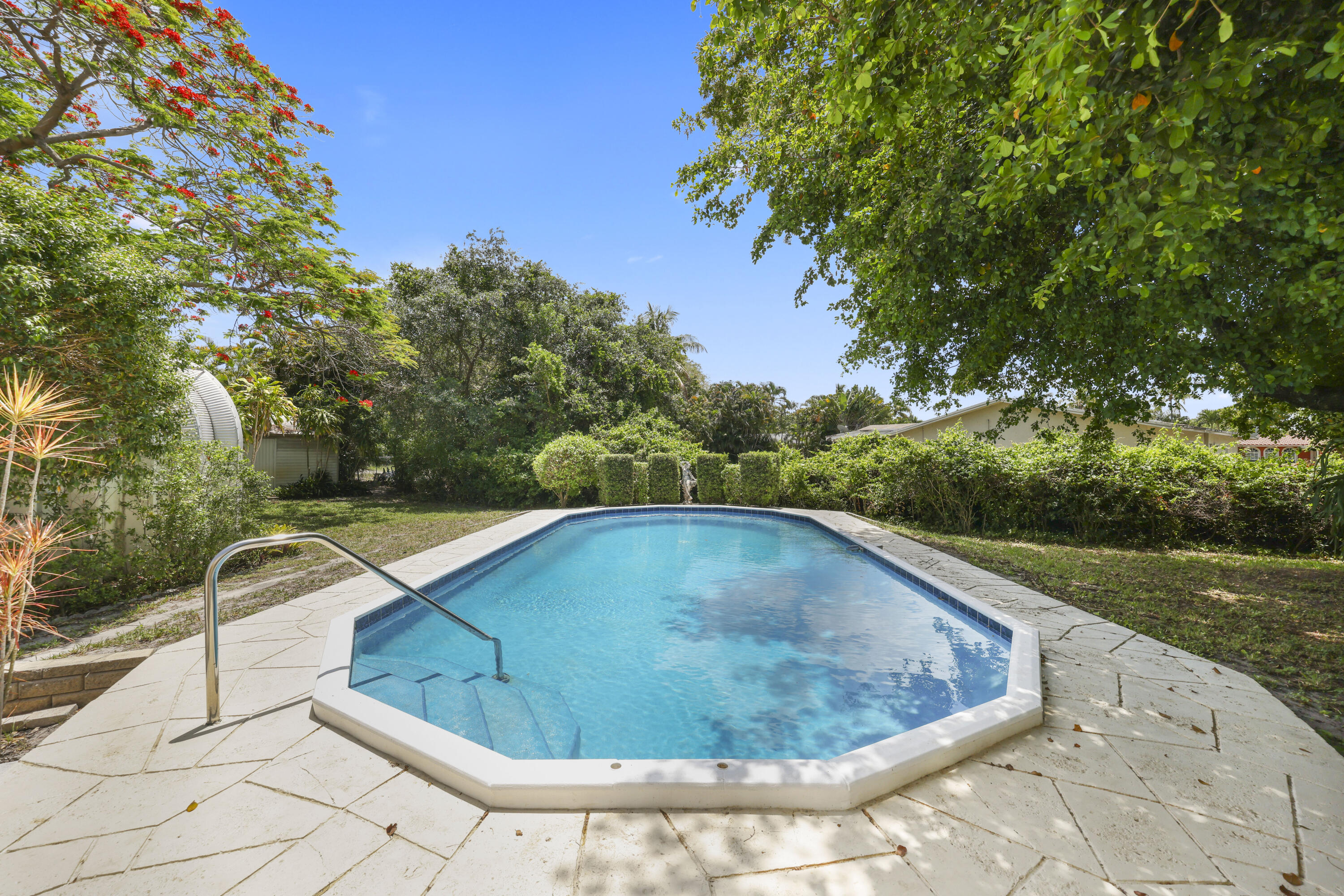 1720 Southwest 10th Street Boca Raton, FL 33486 - Photo 39 of 57 a view of a swimming pool with a yard