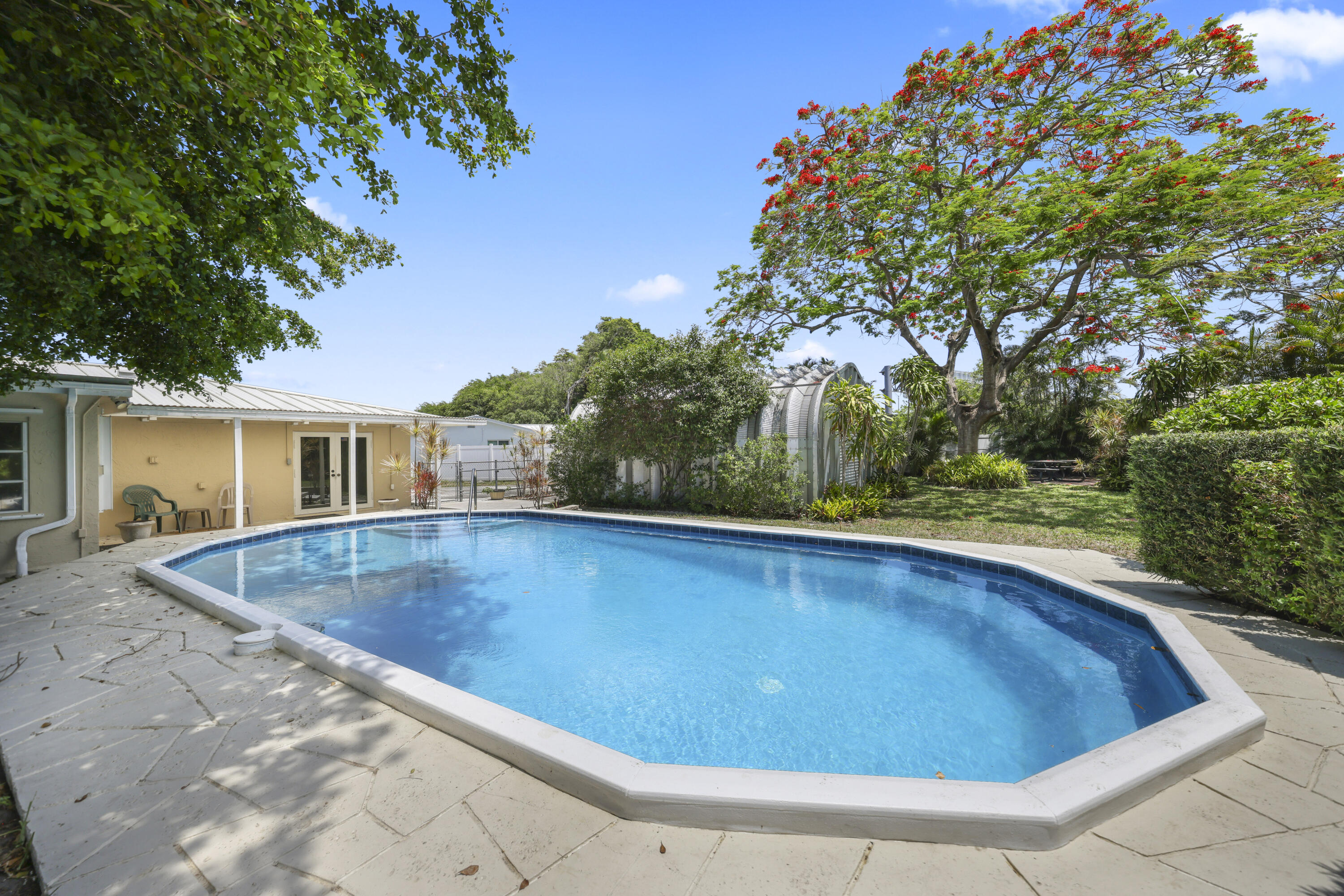 1720 Southwest 10th Street Boca Raton, FL 33486 - Photo 42 of 57 a view of a swimming pool with a patio