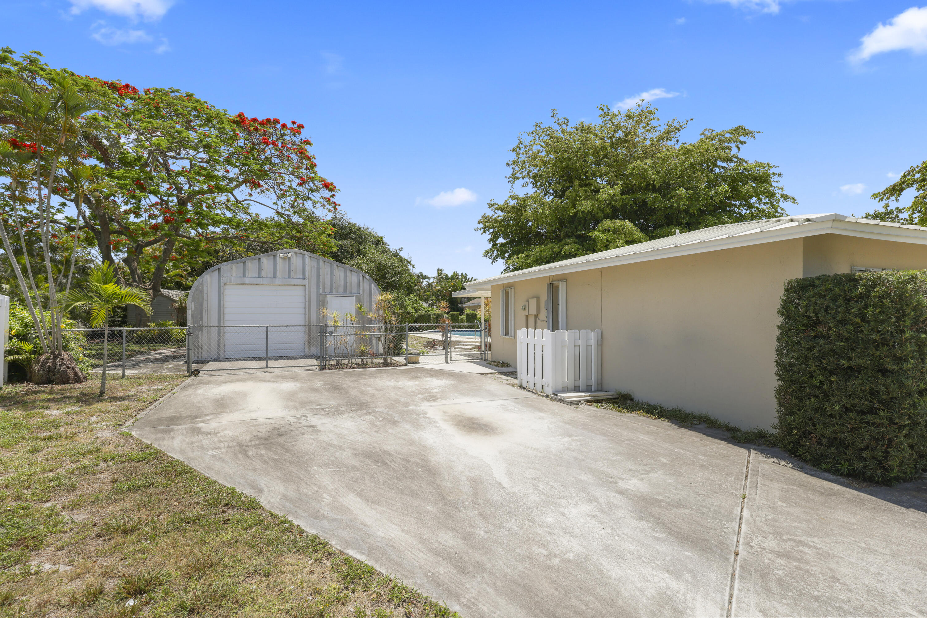 1720 Southwest 10th Street Boca Raton, FL 33486 - Photo 5 of 57 a backyard of a house with plants and trees