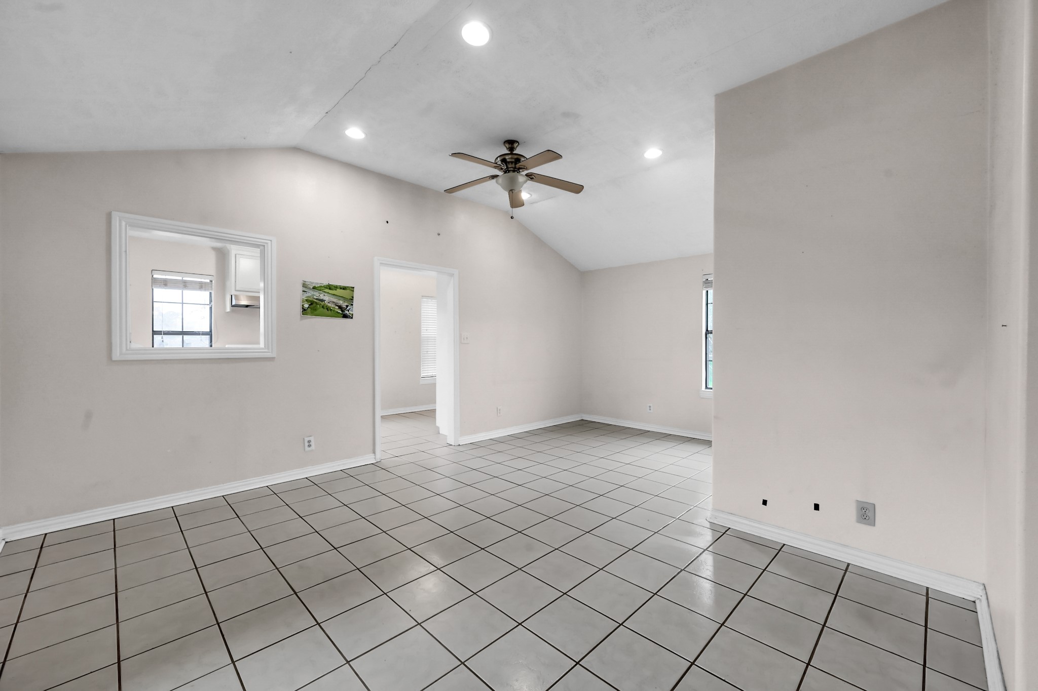 7644 Spring Cypress Road Spring, TX 77379 - Photo 18 of 28 an empty room with windows and fan