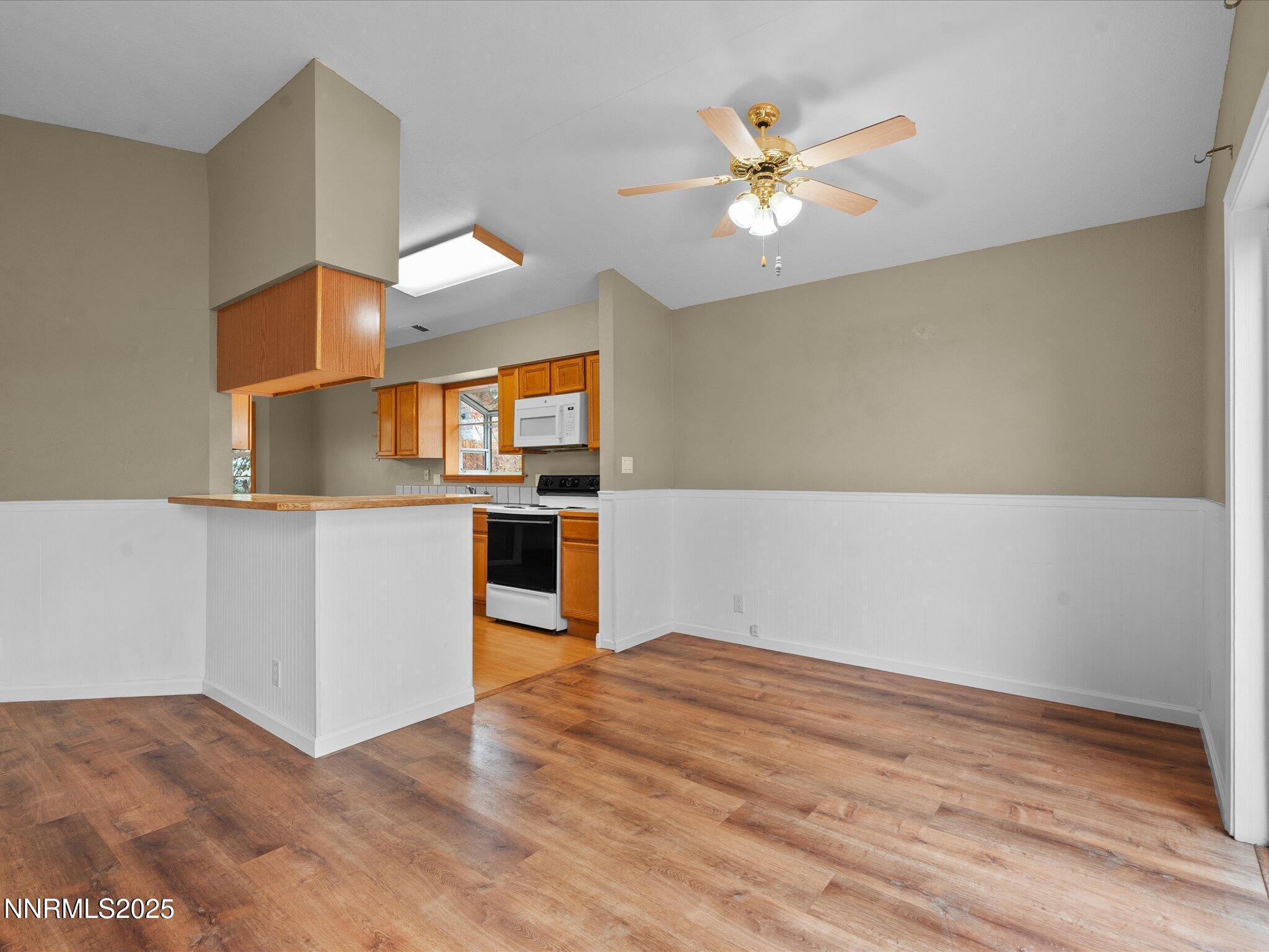 732 Talus Way Reno, NV 89503 - Photo 11 of 50 a kitchen with stainless steel appliances kitchen island a chandelier wooden cabinets and a fireplace