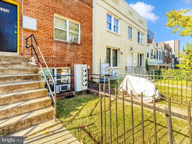 a view of building with swimming pool and sitting area