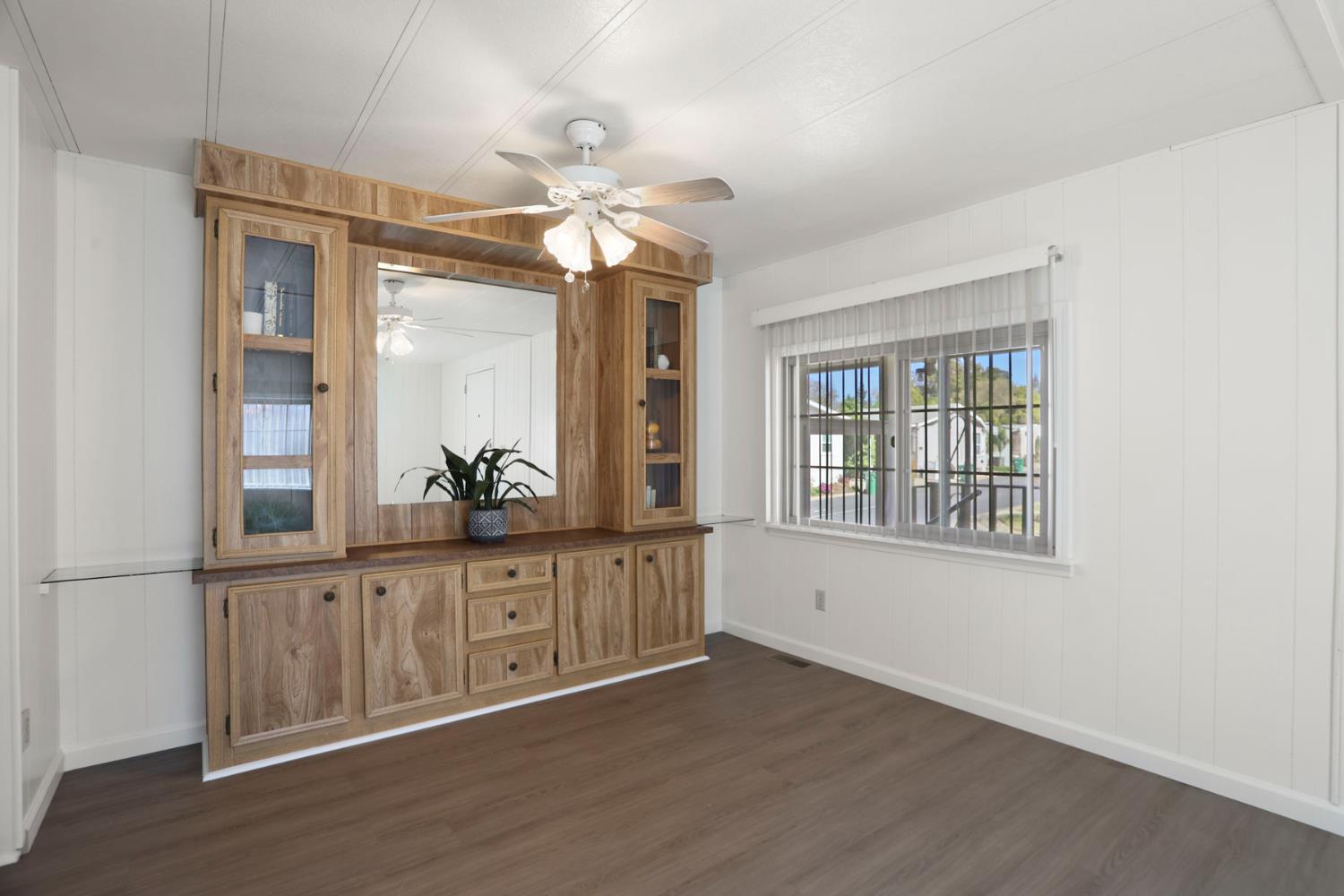19 Rio Vista Drive Lodi, CA 95240 - Photo 15 of 34 an empty room with wooden floor fan and windows