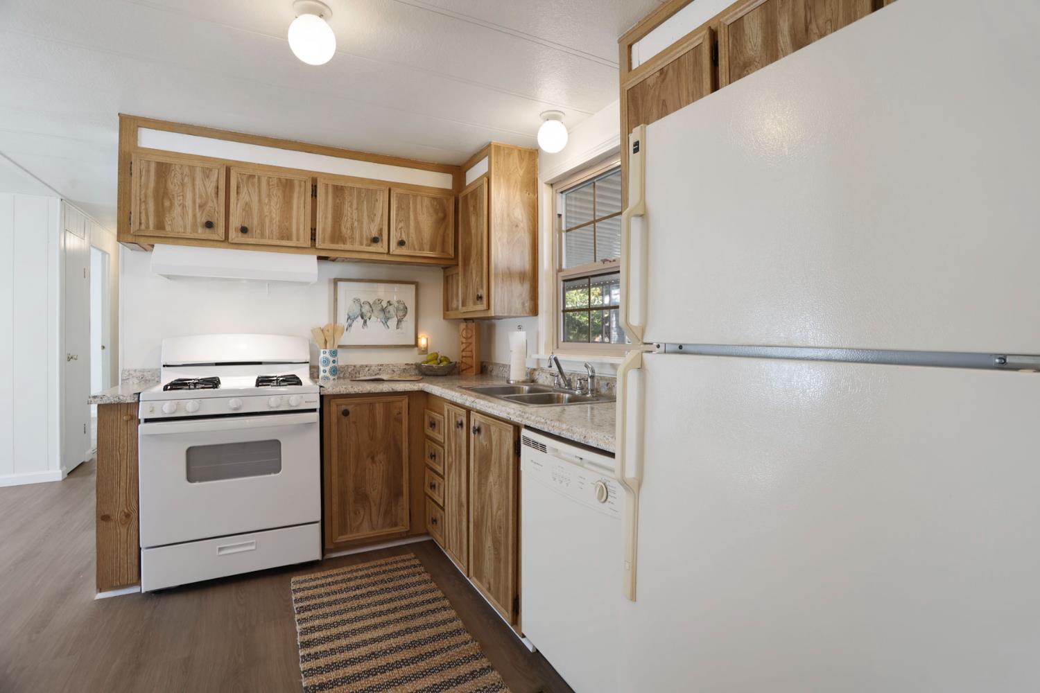 19 Rio Vista Drive Lodi, CA 95240 - Photo 17 of 34 a kitchen with stainless steel appliances granite countertop a stove a sink and a refrigerator
