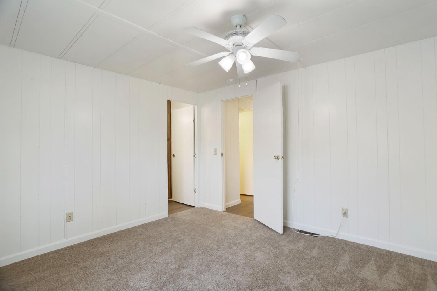 19 Rio Vista Drive Lodi, CA 95240 - Photo 29 of 34 an empty room with a chandelier fan and windows