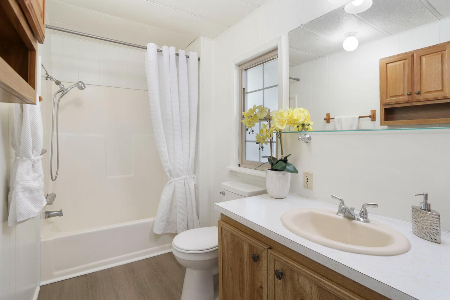 19 Rio Vista Drive Lodi, CA 95240 - Photo 31 of 34 a bathroom with a granite countertop sink toilet and shower