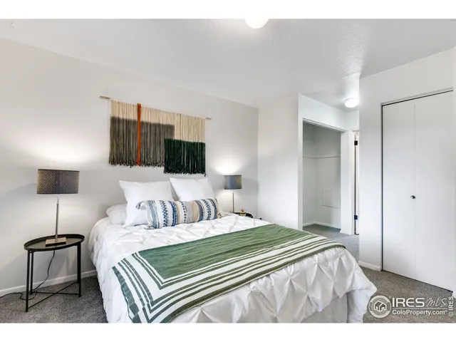 a bedroom with a bed and a lamp