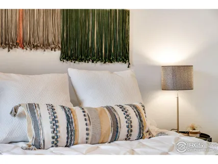 a view of a bedroom with a couch and a potted plant