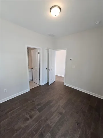 a view of an empty room and wooden floor