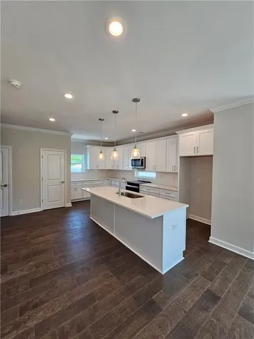 a kitchen with stainless steel appliances white cabinets and a sink