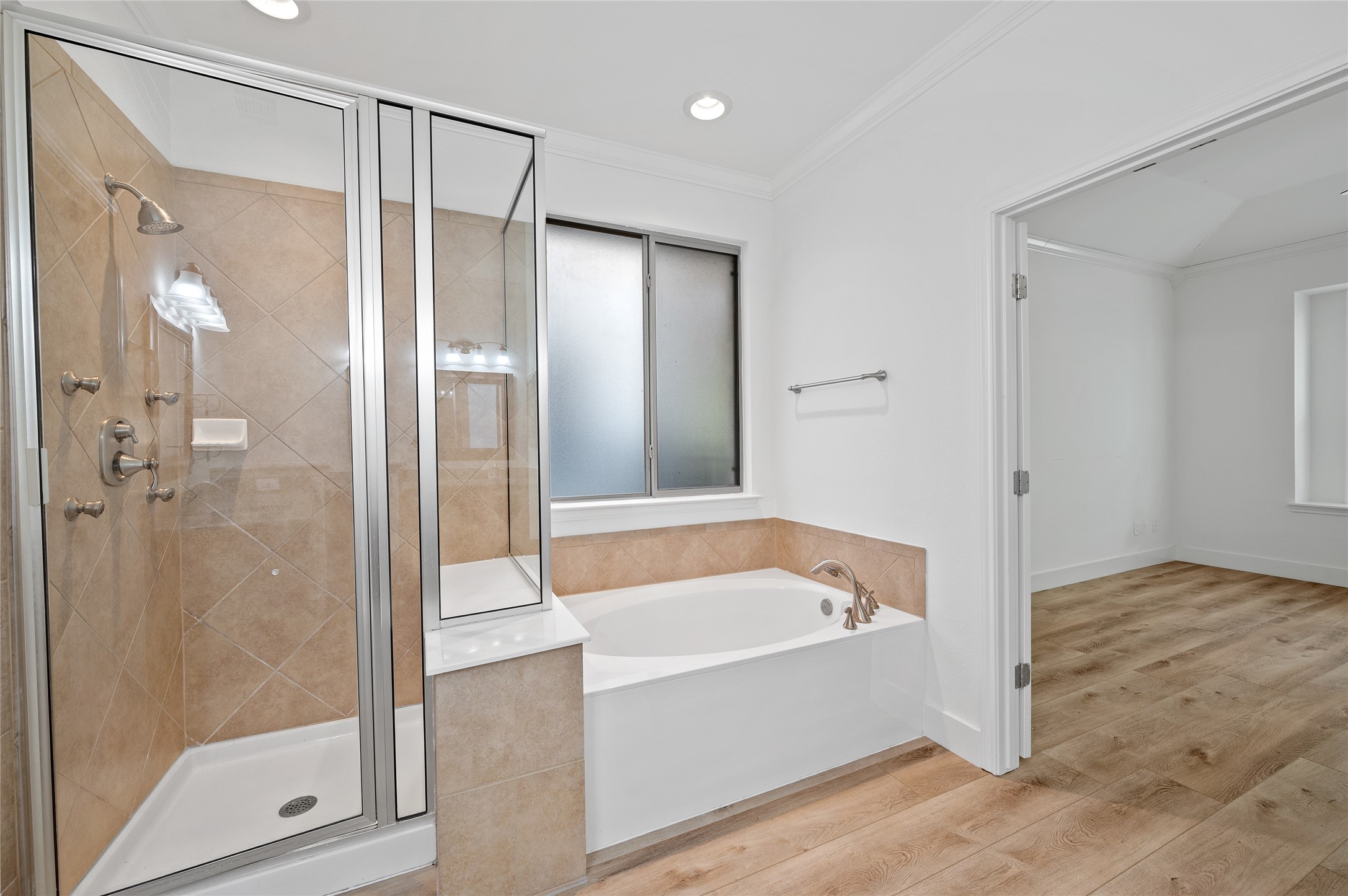 4512 Pyrenees Pass Bee Cave, TX 78738 - Photo 20 of 35 a bathroom with a bathtub and a shower
