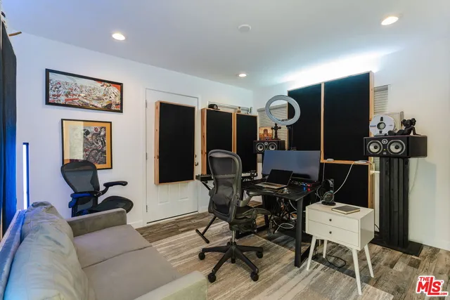 a view of a livingroom with workspace and couch
