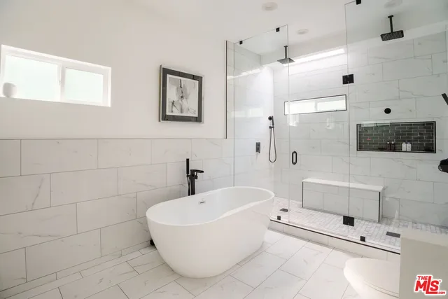 a bathroom with a bathtub and a shower