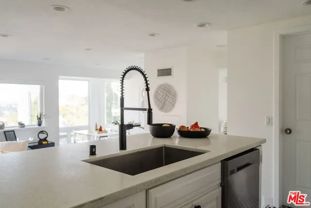 a kitchen with a sink and large window