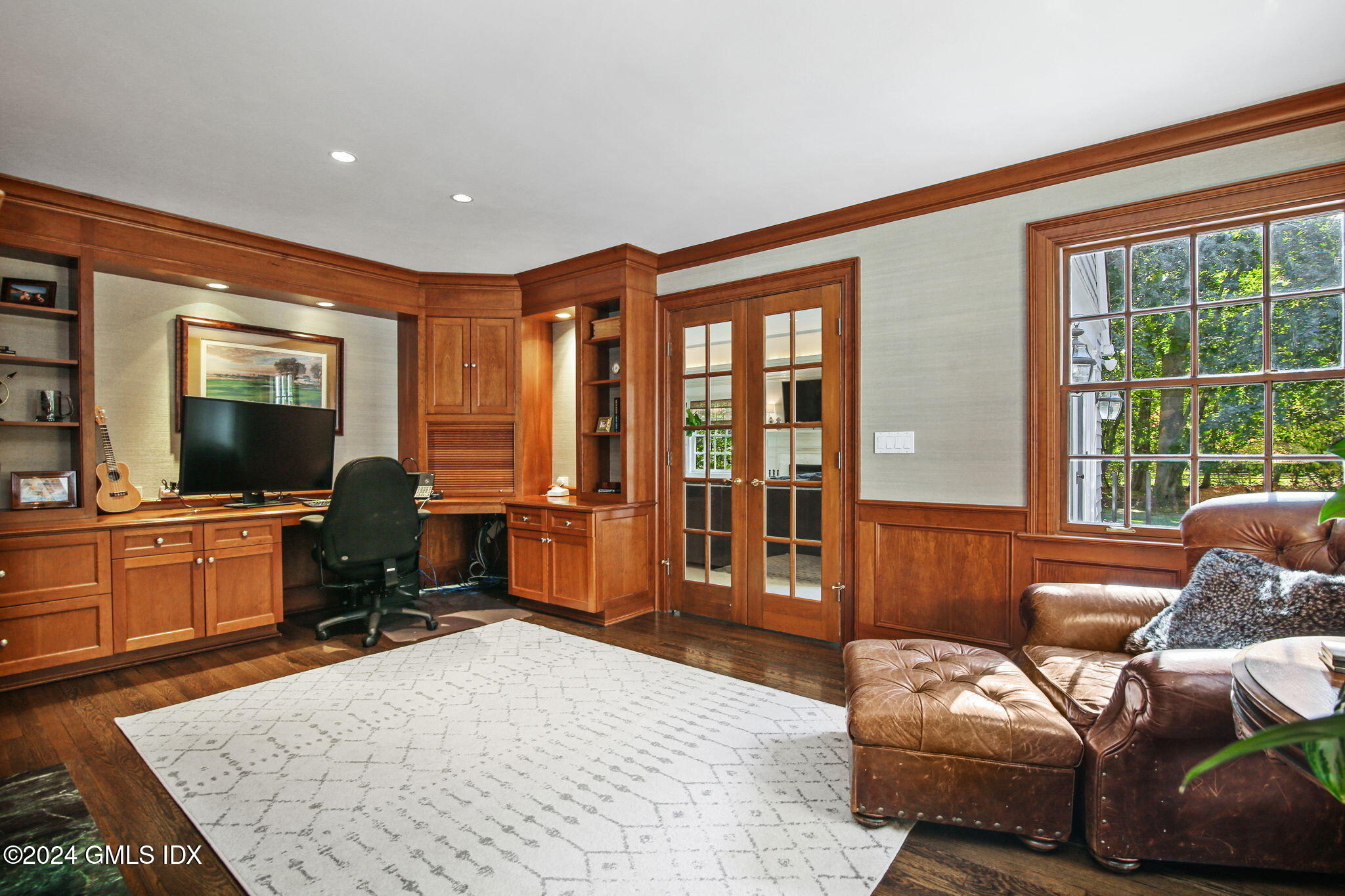 49 Grosset Road Riverside, CT 06878 - Photo 12 of 41 a living room with furniture a flat screen tv and a floor to ceiling window