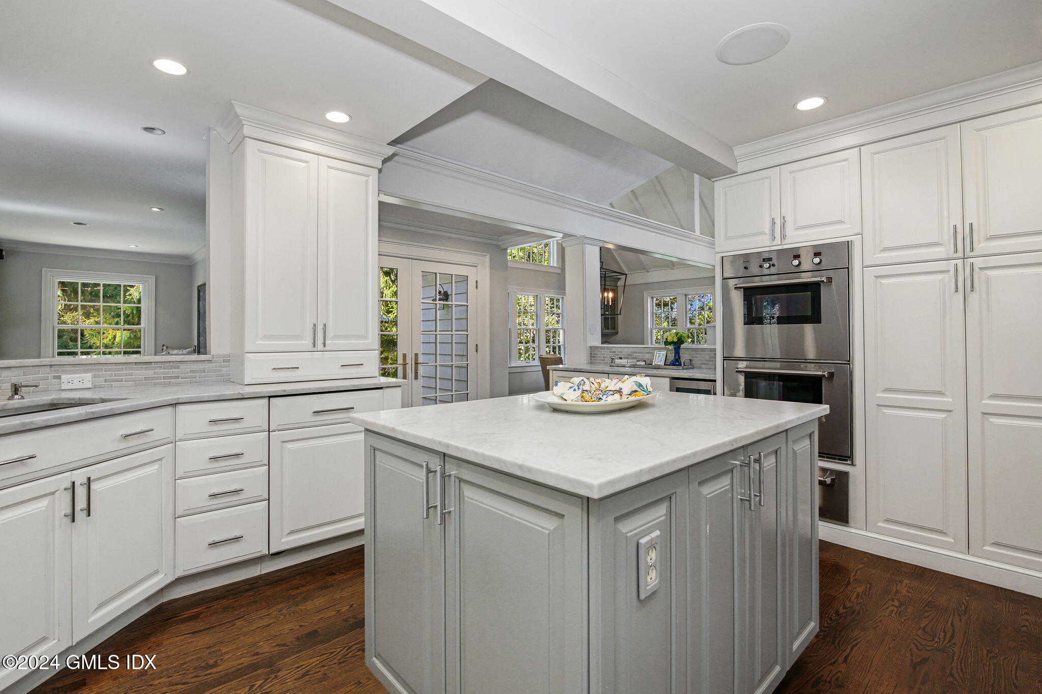 49 Grosset Road Riverside, CT 06878 - Photo 16 of 41 a kitchen with stainless steel appliances cabinets and wooden floor
