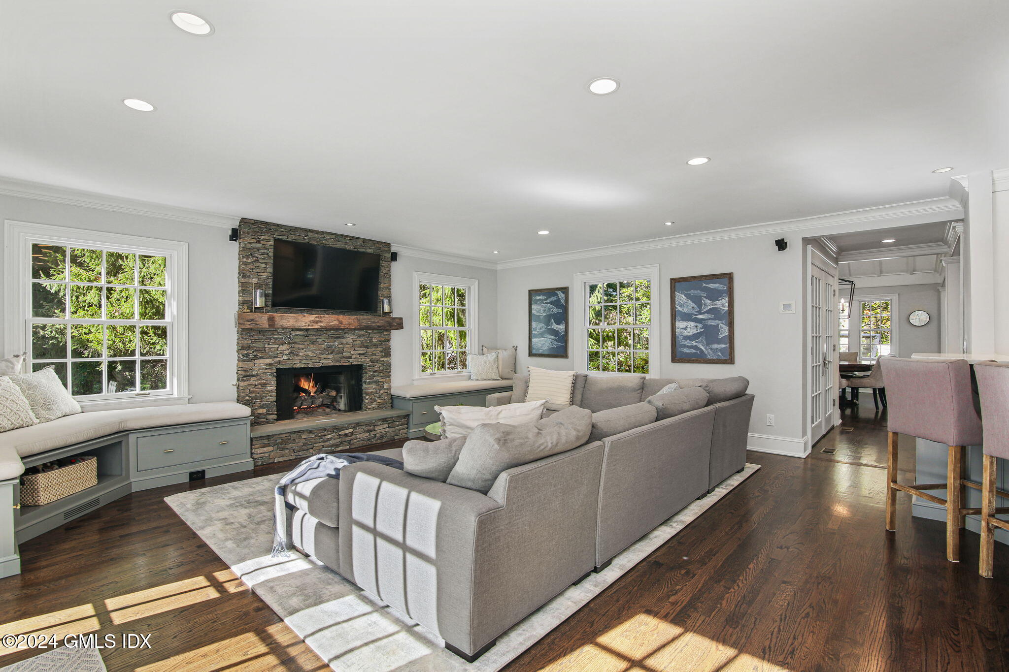 49 Grosset Road Riverside, CT 06878 - Photo 18 of 41 a living room with furniture a flat screen tv and a fireplace