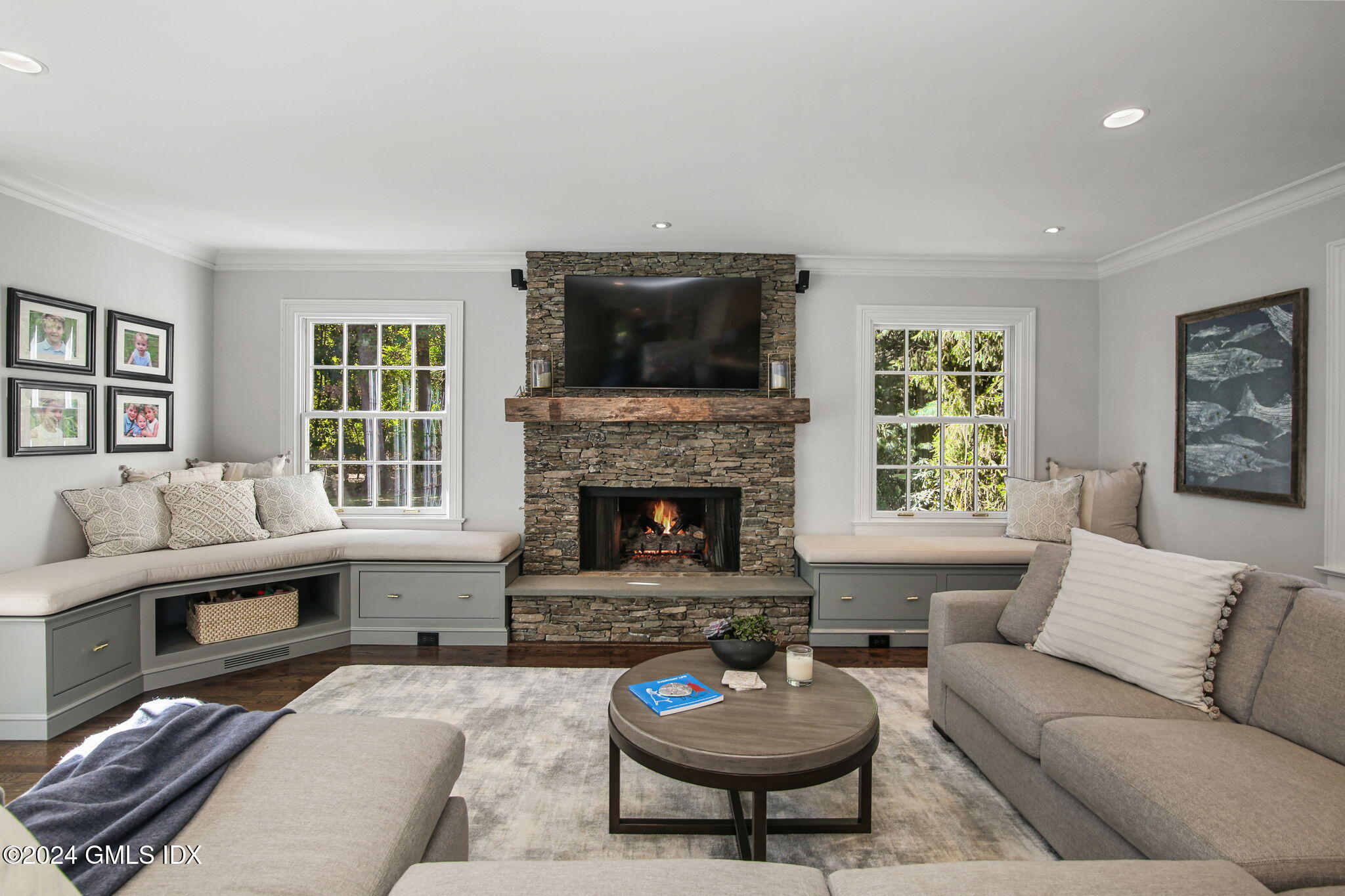 49 Grosset Road Riverside, CT 06878 - Photo 21 of 41 a living room with furniture a flat screen tv and a fireplace