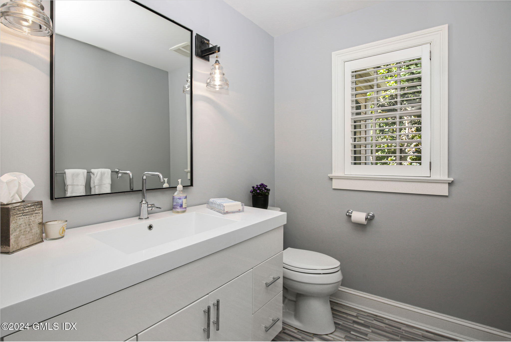49 Grosset Road Riverside, CT 06878 - Photo 34 of 41 a bathroom with a sink a toilet and a mirror