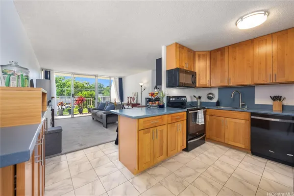 a kitchen with stainless steel appliances granite countertop a stove a sink dishwasher and a refrigerator