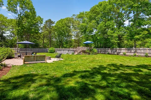 a view of a swimming pool with lounge chairs in the patio