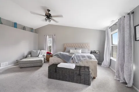 a bedroom with a bed couch and a window
