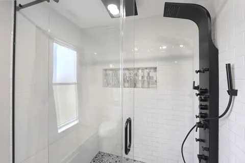 a bathroom with a bathtub and a shower