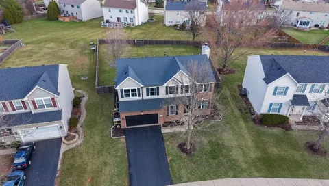 an aerial view of houses with yard