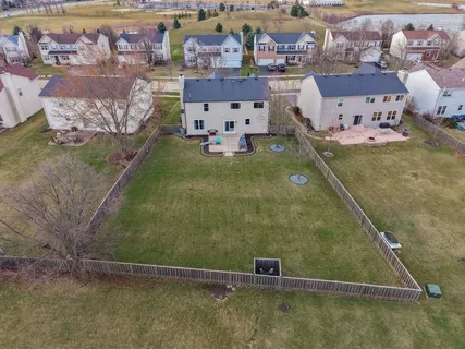 with aerial view of a house with a yard