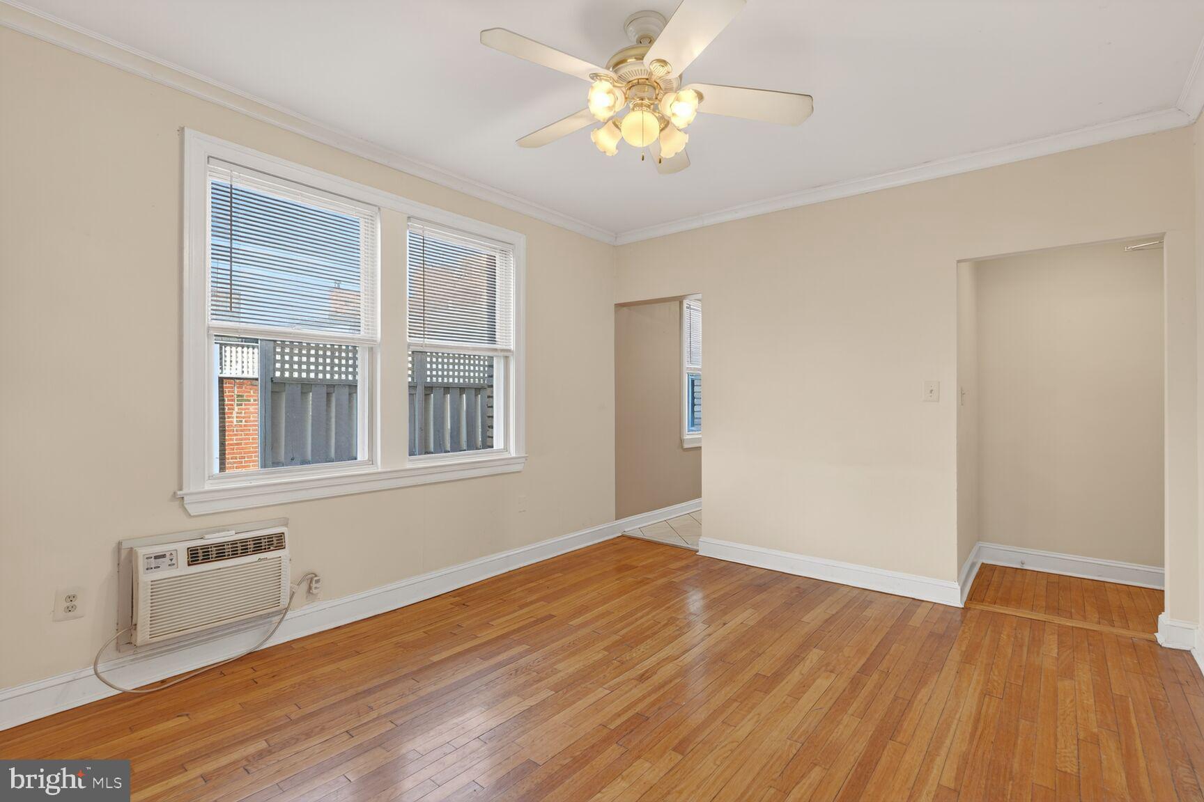 1820 Swann Street Northwest, Unit 303 Washington, DC 20009 - Photo 4 of 10 a view of an empty room with wooden floor and a window