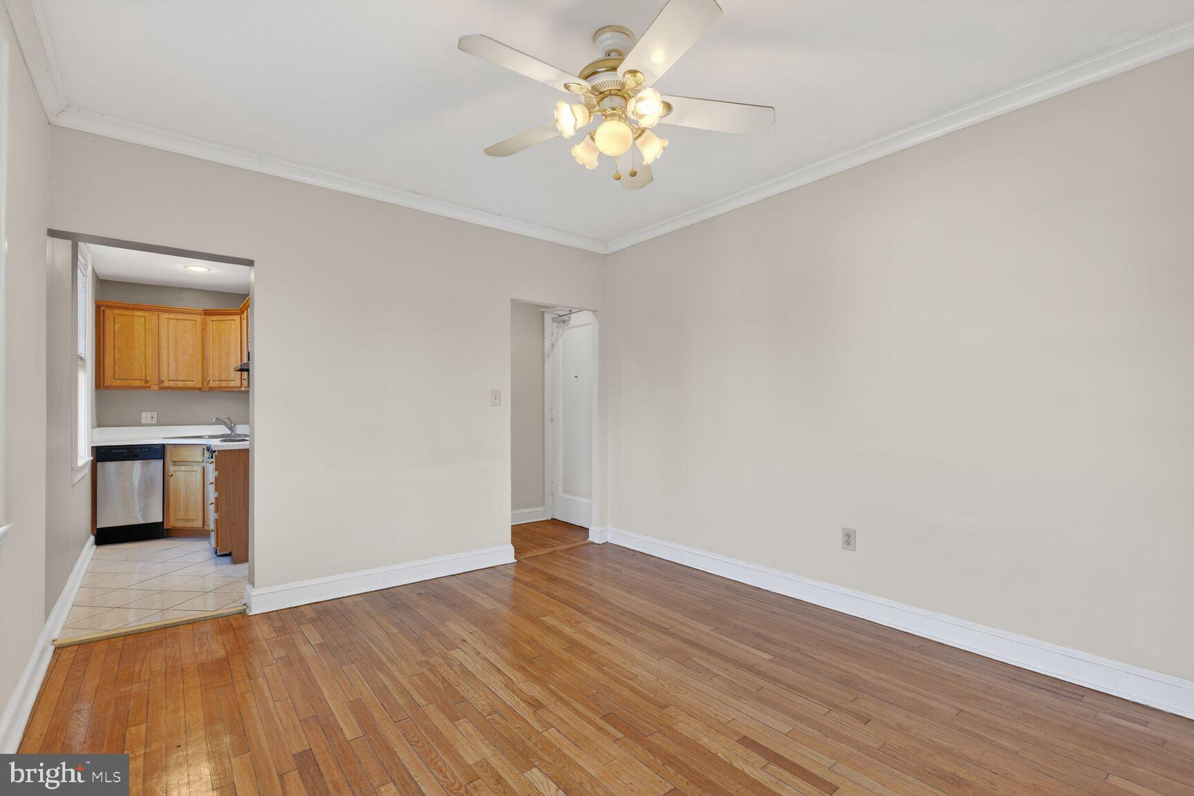 1820 Swann Street Northwest, Unit 303 Washington, DC 20009 - Photo 5 of 10 a view of an empty room with window and wooden floor