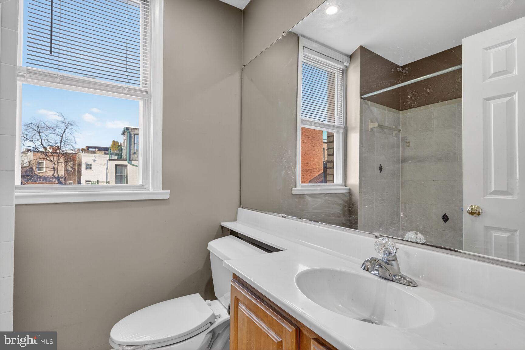 1820 Swann Street Northwest, Unit 303 Washington, DC 20009 - Photo 10 of 10 a bathroom with a sink toilet and mirror