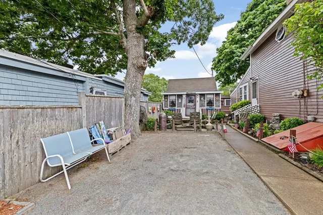 a view of backyard with outdoor seating and plants