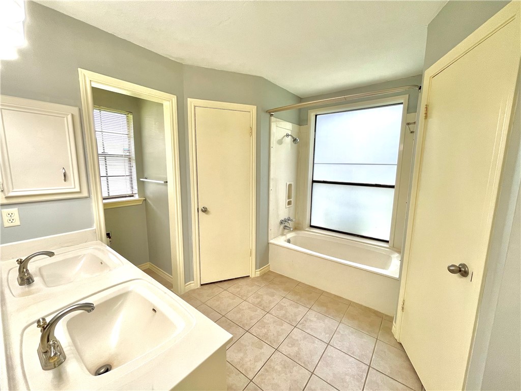4508 Kensington Road Bryan, TX 77802 - Photo 14 of 25 Bathroom with vanity, tile patterned floors, and independent shower and bath