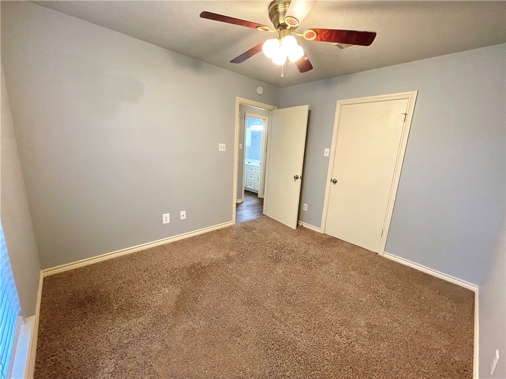 4508 Kensington Road Bryan, TX 77802 - Photo 19 of 25 Carpeted empty room with ceiling fan