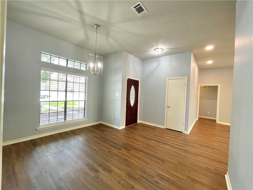 4508 Kensington Road Bryan, TX 77802 - Photo 2 of 25 Entrance foyer with wood-type flooring and a notable chandelier