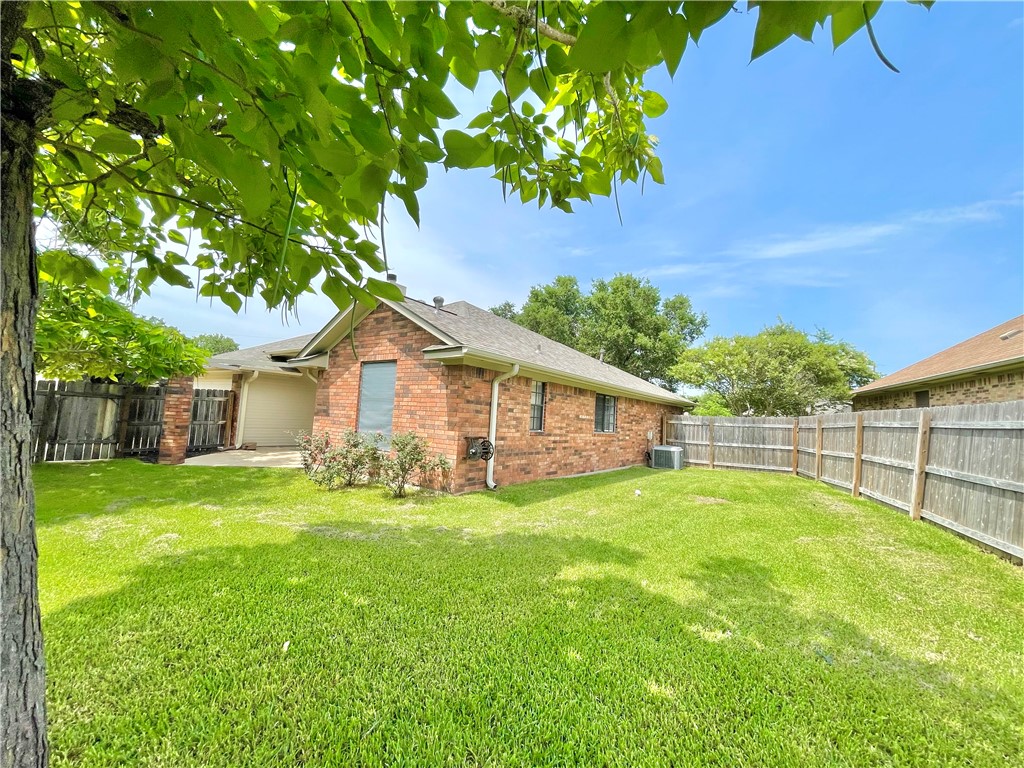 4508 Kensington Road Bryan, TX 77802 - Photo 24 of 25 View of property exterior with a patio, central air condition unit, and a lawn
