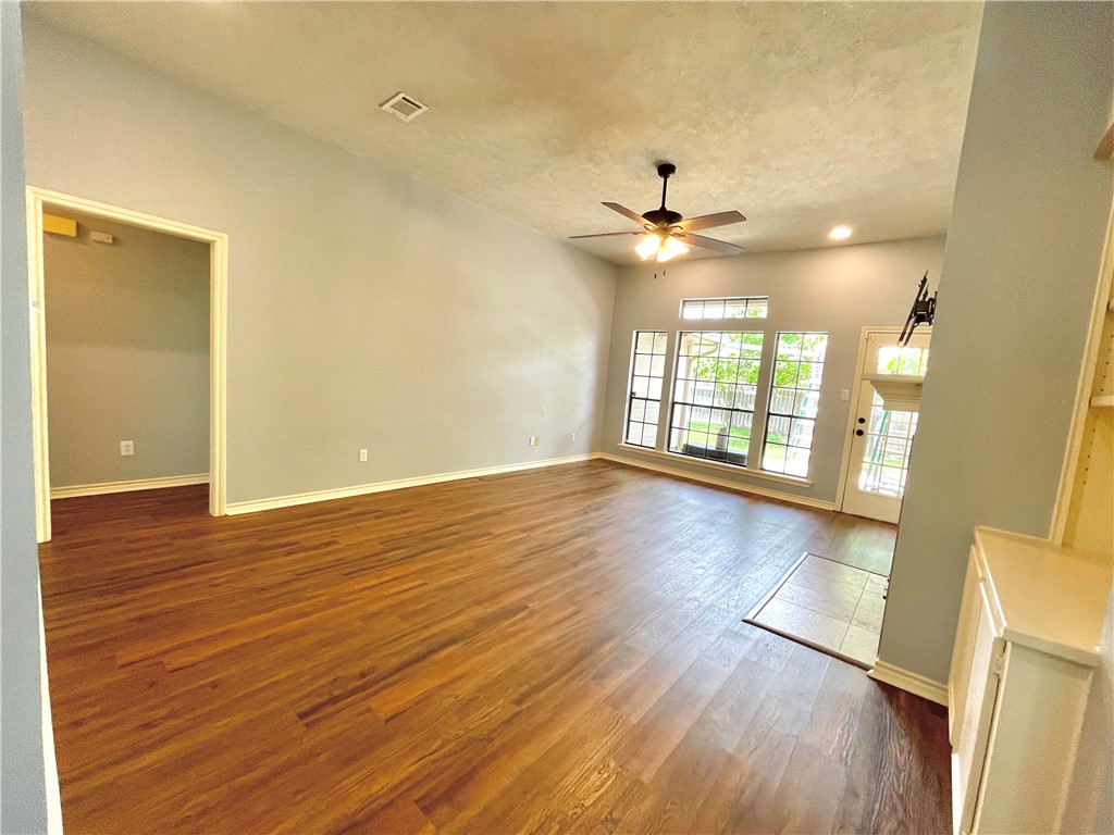 4508 Kensington Road Bryan, TX 77802 - Photo 4 of 25 Unfurnished living room with hardwood / wood-style flooring, a textured ceiling, and ceiling fan